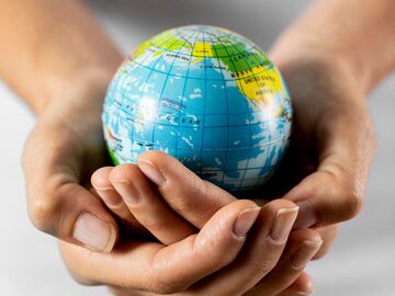 person-holding-earth-globe_23-2148748639.jpg