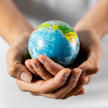 person-holding-earth-globe_23-2148748639.jpg